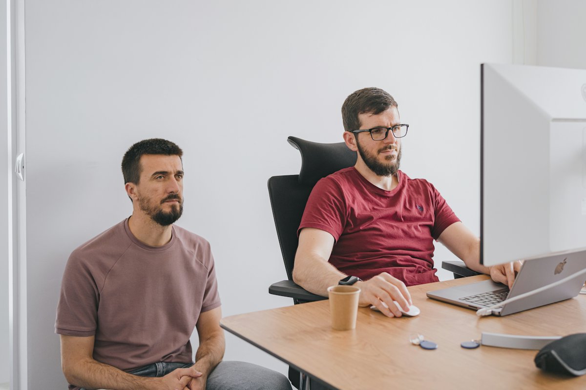 Two colleagues working together at a laptop